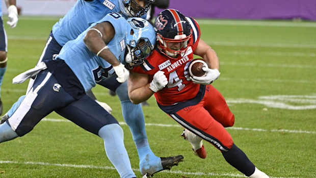 Nov 11, 2023; Toronto, Ontario, CAN; Montreal Alouettes fullback James Tuck (40) is stopped by Toronto Argonauts defensive back Adarius Pickett (6) in the second half at BMO Field. Mandatory Credit: Dan Hamilton-USA TODAY Sports